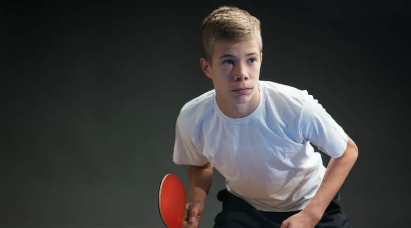 Junge steht in der Tischtennis Grundstellung